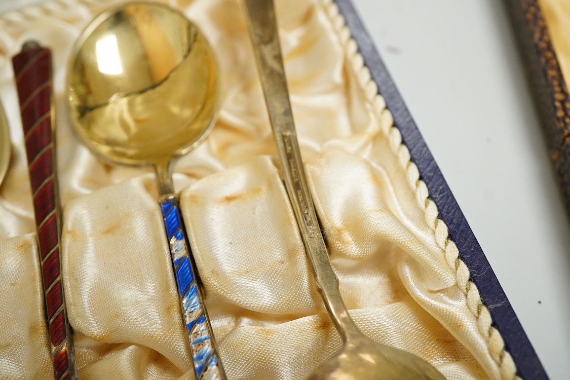 An Edwardian silver elliptical shaped inkstand, with two mounted glass wells and central pen wipe, James Dixon & Sons, Sheffield, 1906, together with ten Danish sterling and polychrome enamel spoons(a.f) and a cased set